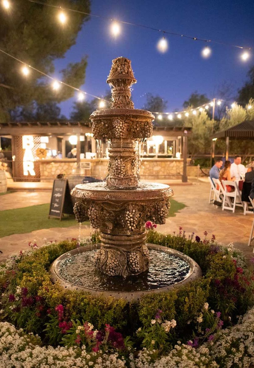 Twinkling lights over a fountain at Lake Oak Meadows wedding venue in Temecula, CA